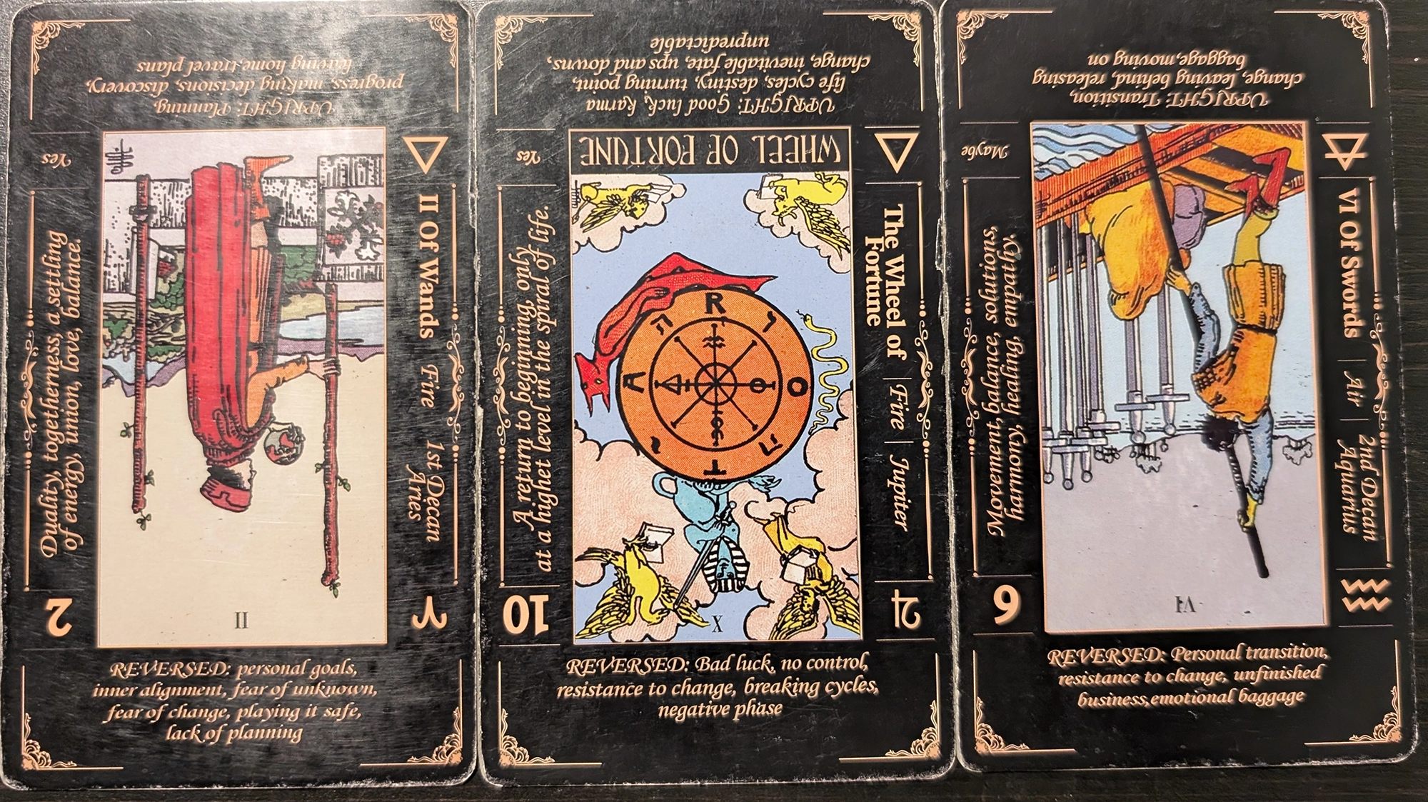 3 cards from the Classic Tarot deck of the Two of Wands, Wheel of Fortune, and the Six of Swords. 