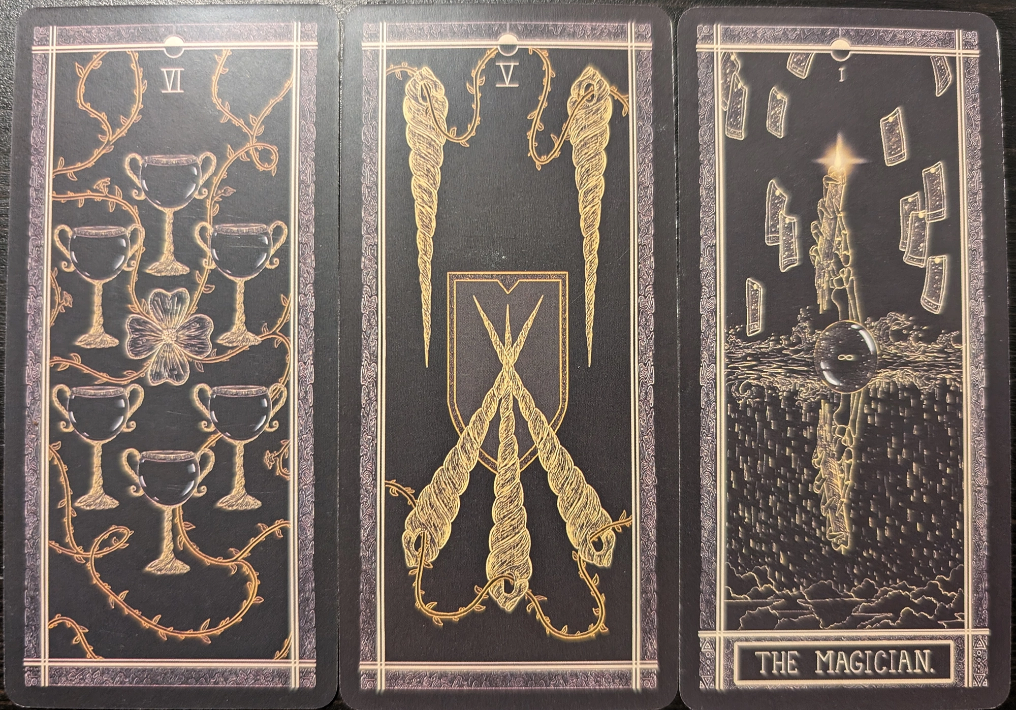 3 Cards from The Kinner Tarot deck of the Six of Cups, Five of Wands, and The Magician. 