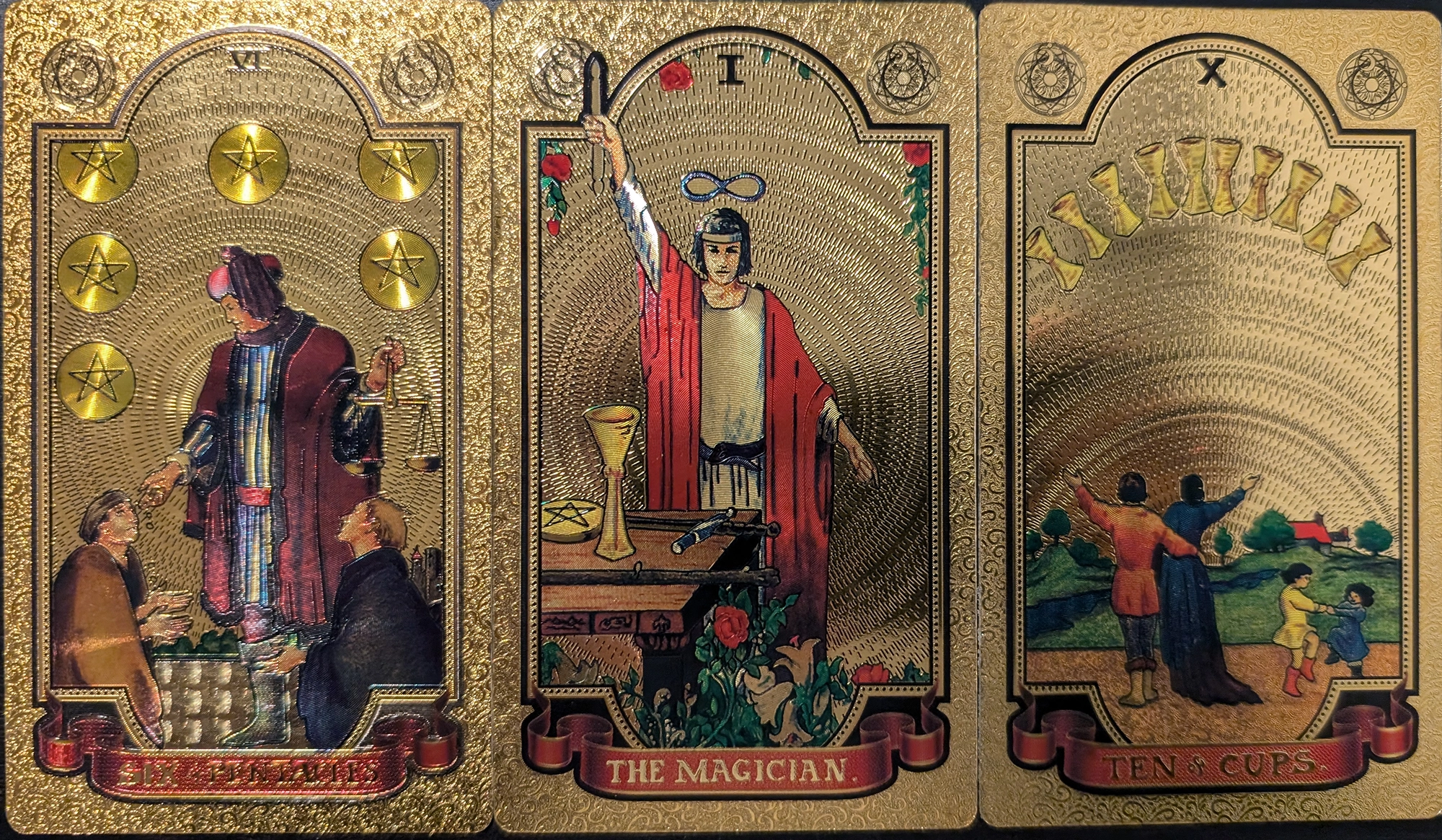 3 cards from the Gold Foil tarot of Six of Pentacles, The Magician, and Ten of Cups