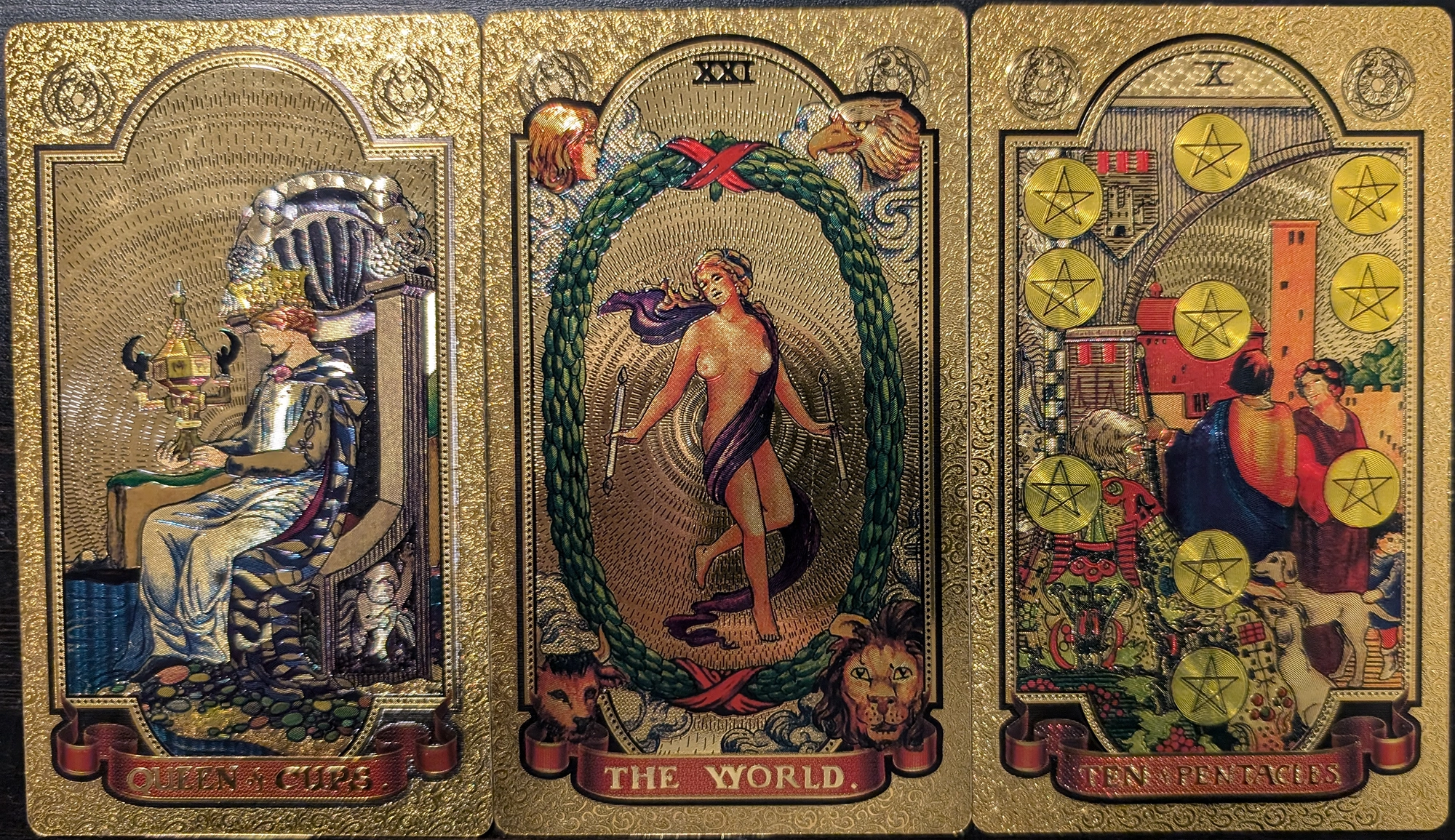 3 cards from the Gold Foil Tarot deck of Queen of Cups, The World, Ten of Pentacles