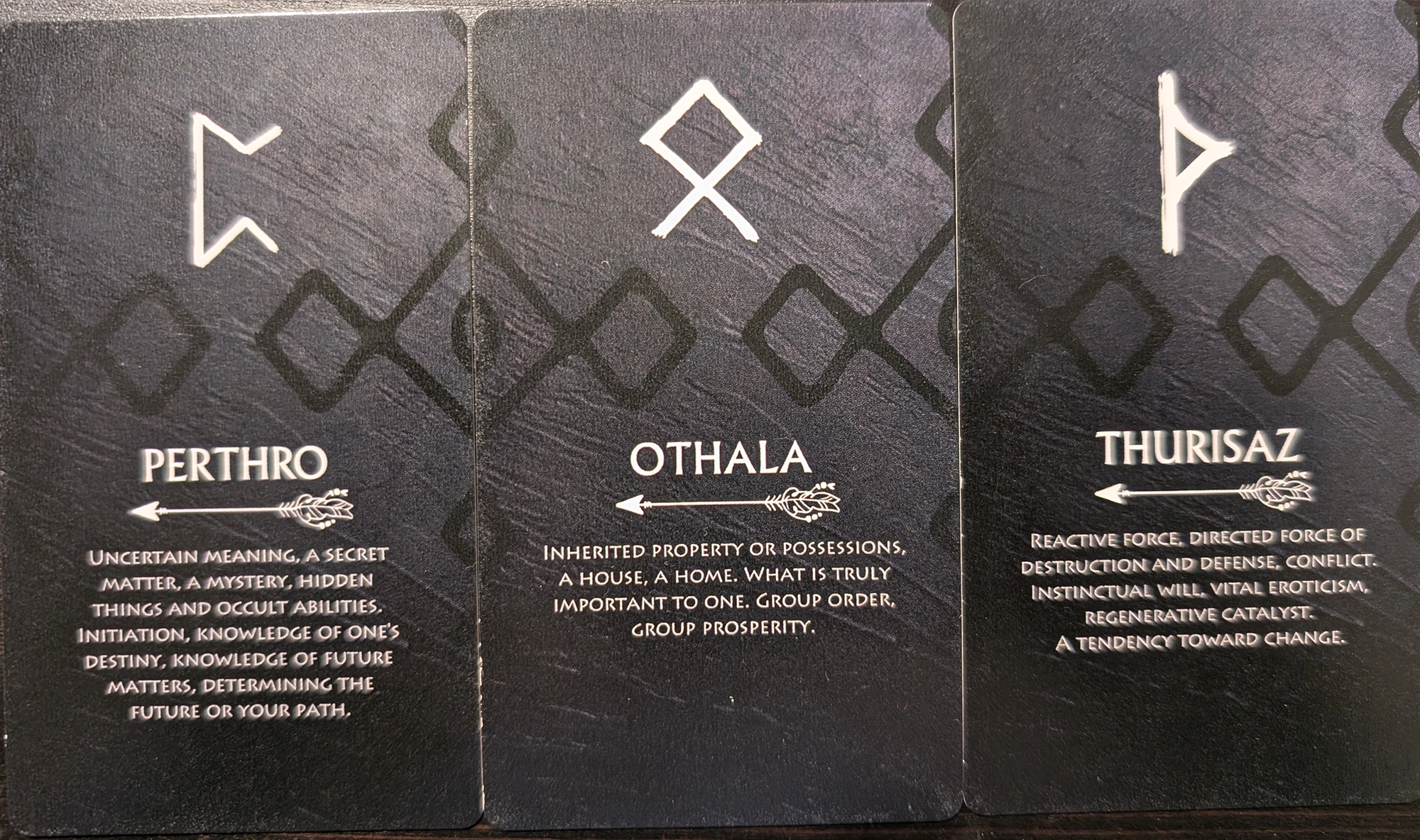 3 cards from the Runes Oracle Deck of Perthro, Othala, and Thurisaz. 