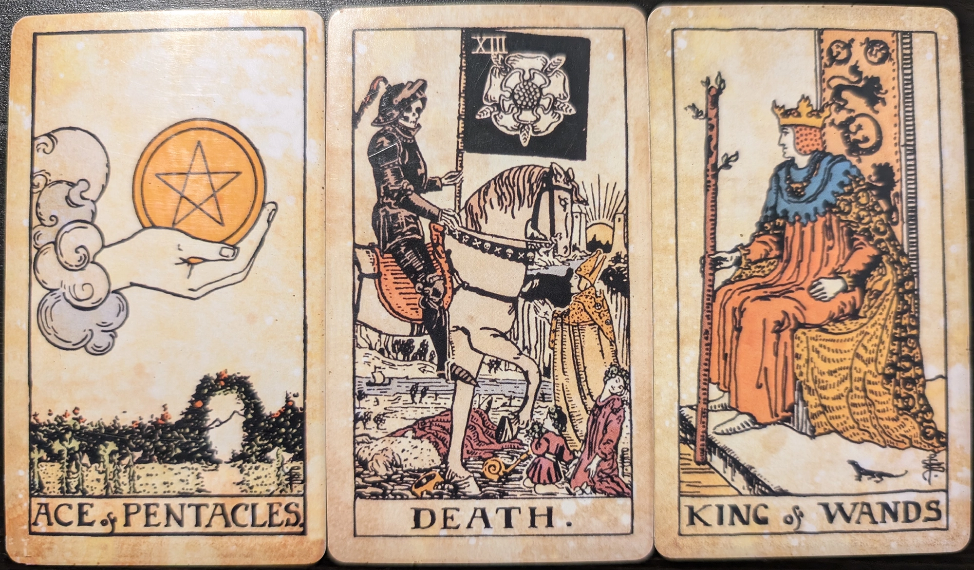 3 cards from the Vintage Tarot of the Ace of Pentacles, Death, and King of Wands. 